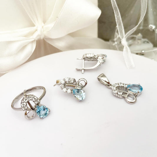 סט אלגנטי של עגילים, טבעת ותליון משובצים בטופז כחול שמיים