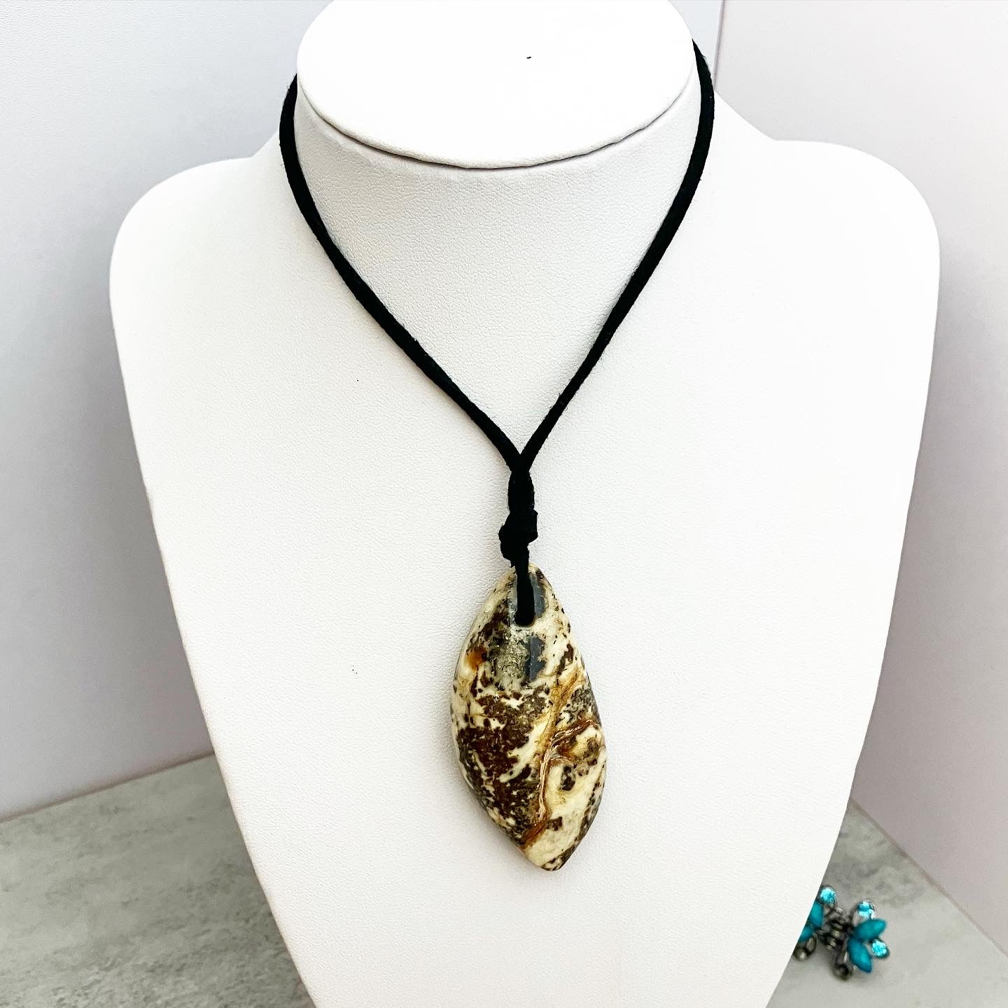 Pendant from amber on a leather cord "Colombia"