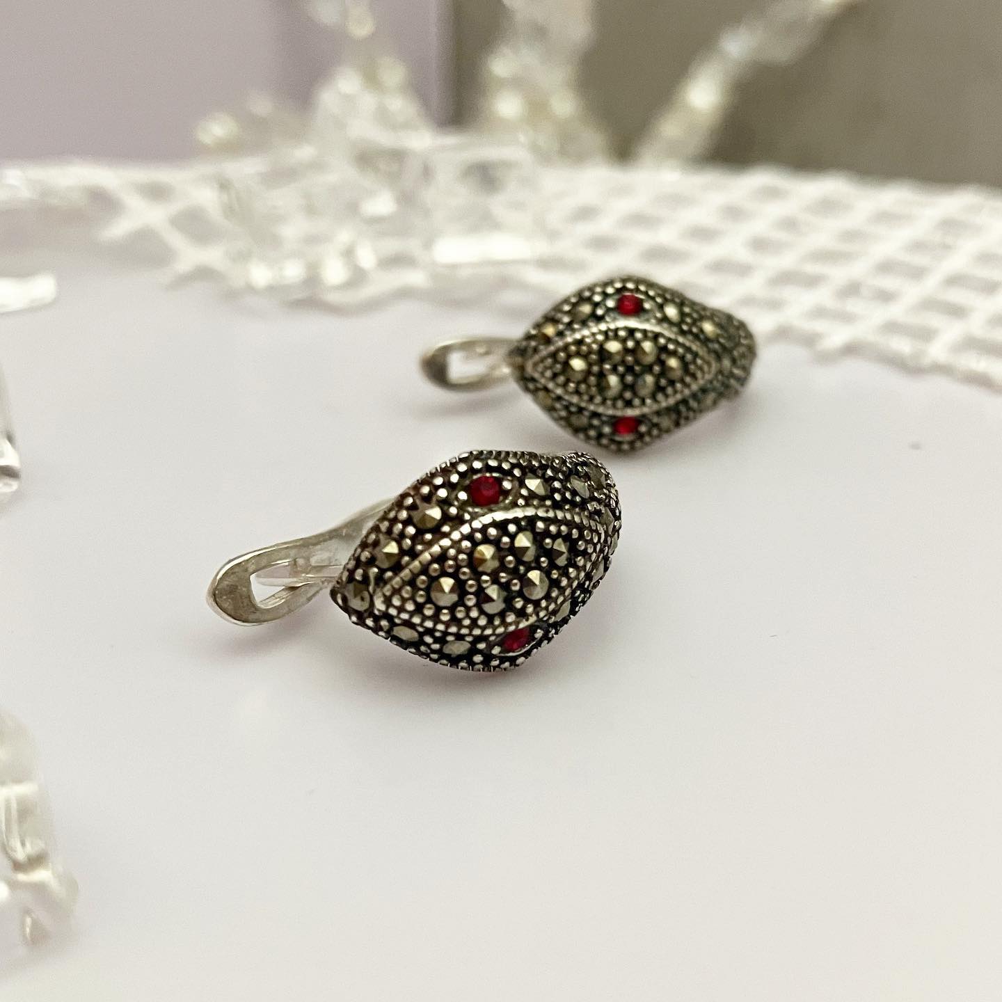 Earrings drip silver.