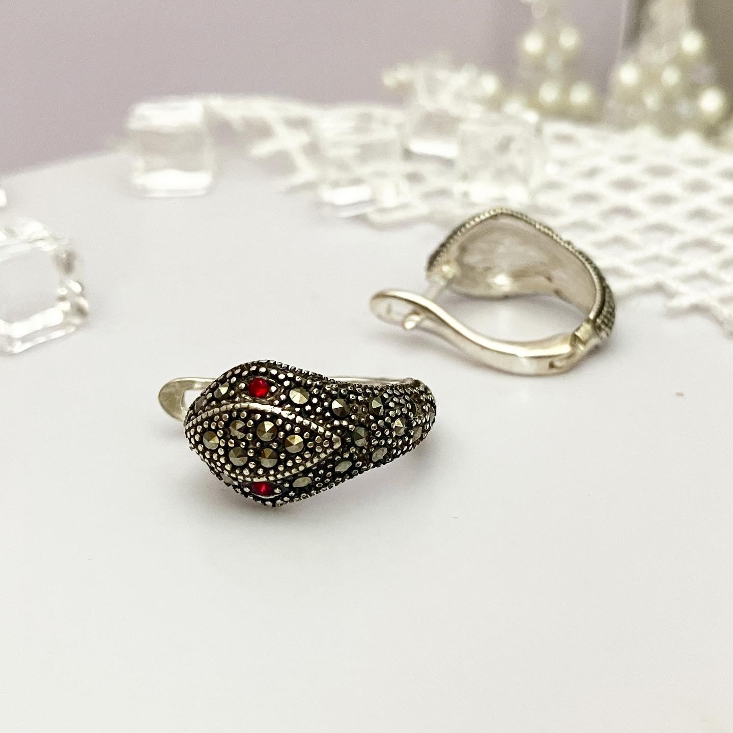 Earrings drip silver.