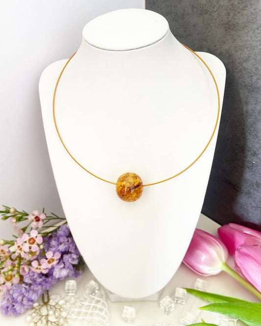 Necklace on a wire with an amber bead