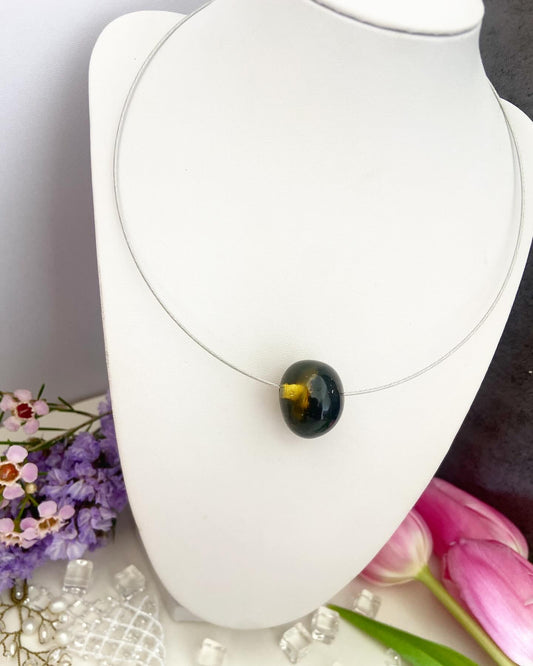 Necklace on a wire with an amber bead