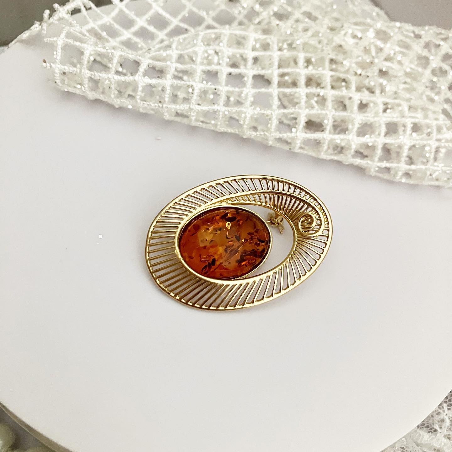 Brooch from silver with gilding and natural amber "Gloria"