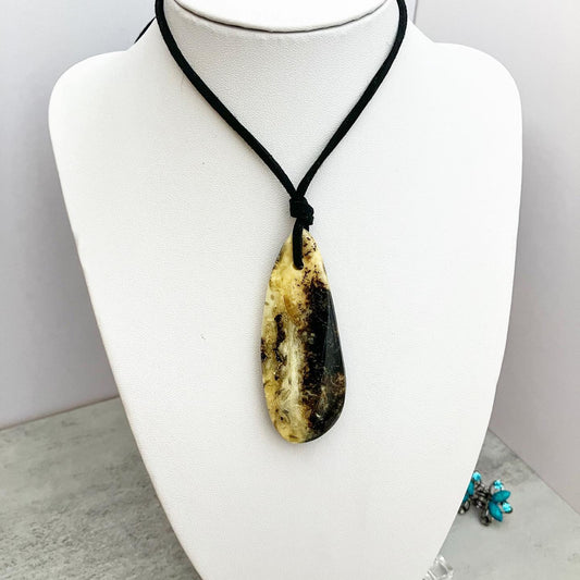 Pendant from amber on a leather cord "Colombia"
