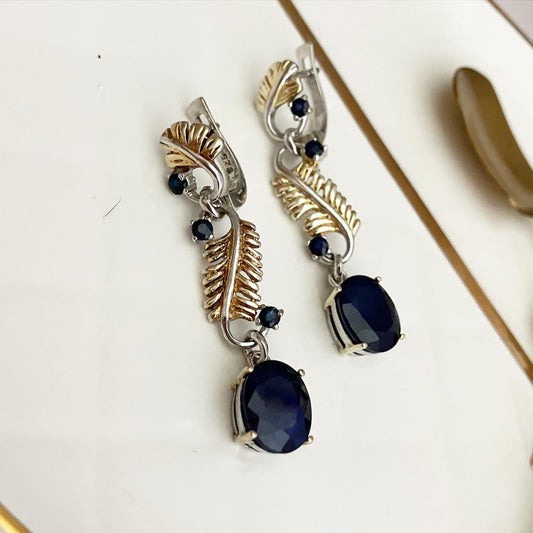 Earrings silver with partial gilding and sapphires.